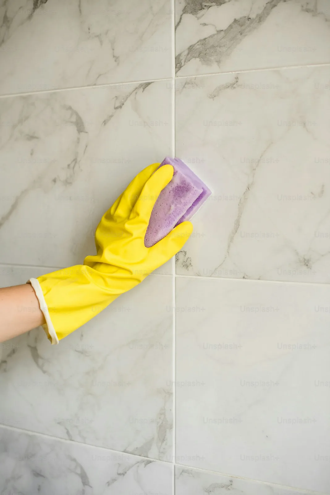 Mopping a tiled floor during grout restoration