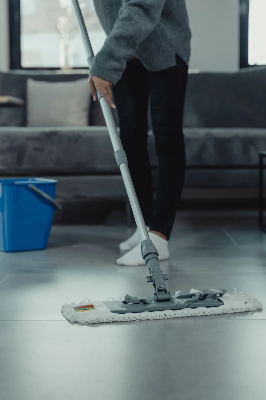 Cleaner detailing a tiled floor
