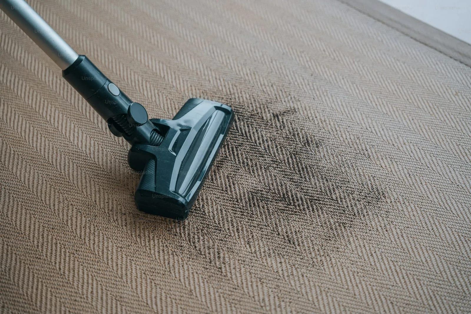 Vacuum cleaning dirt from a carpet